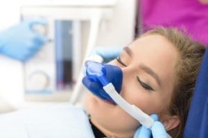Female with a nose mask receiving nitrous oxide dental sedation