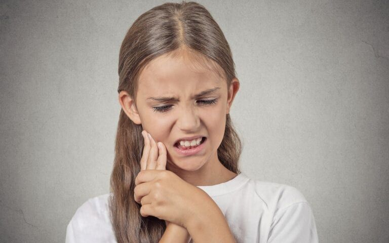 Woman experiencing sensitive teeth