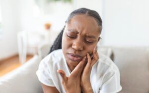 Woman Experiencing Dental Pain at Home